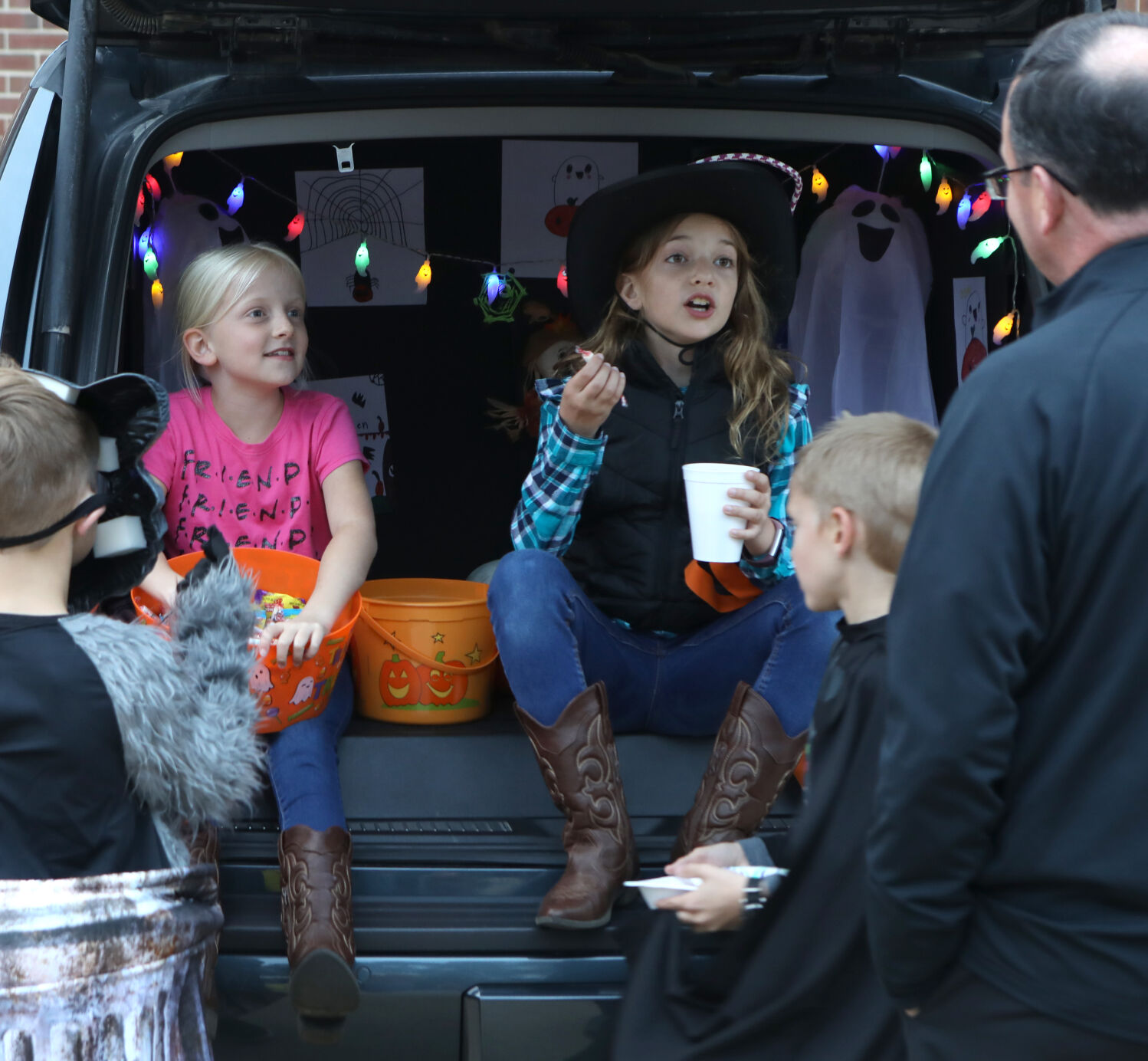 Jodi Kessler and Sydney Wilson hand out candy